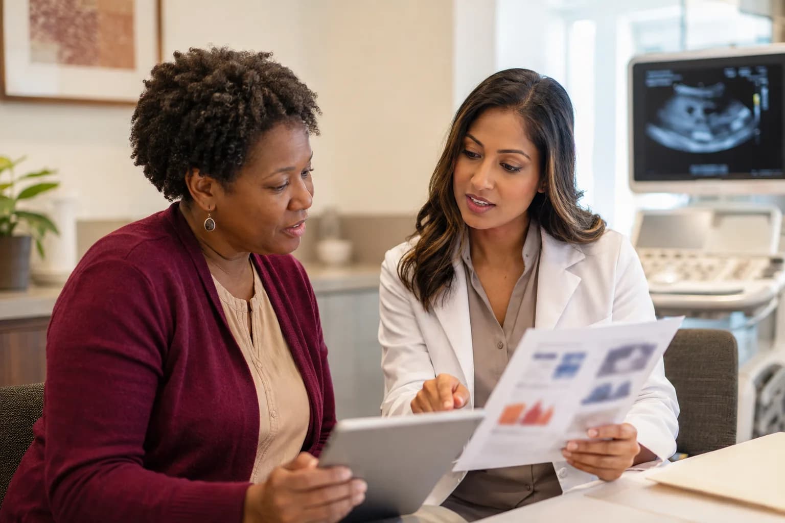 A clinician and patient reviewing screening information together in a private consultation